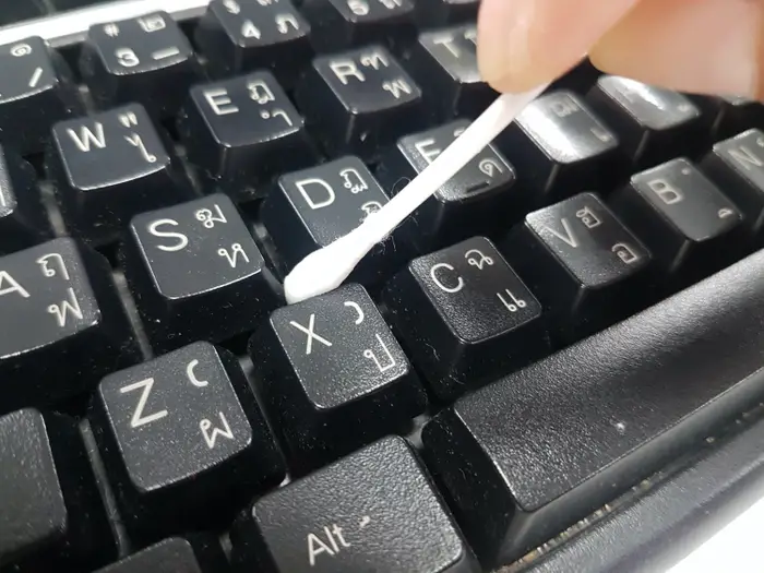 Cleaning the keyboard with Cotton Swab